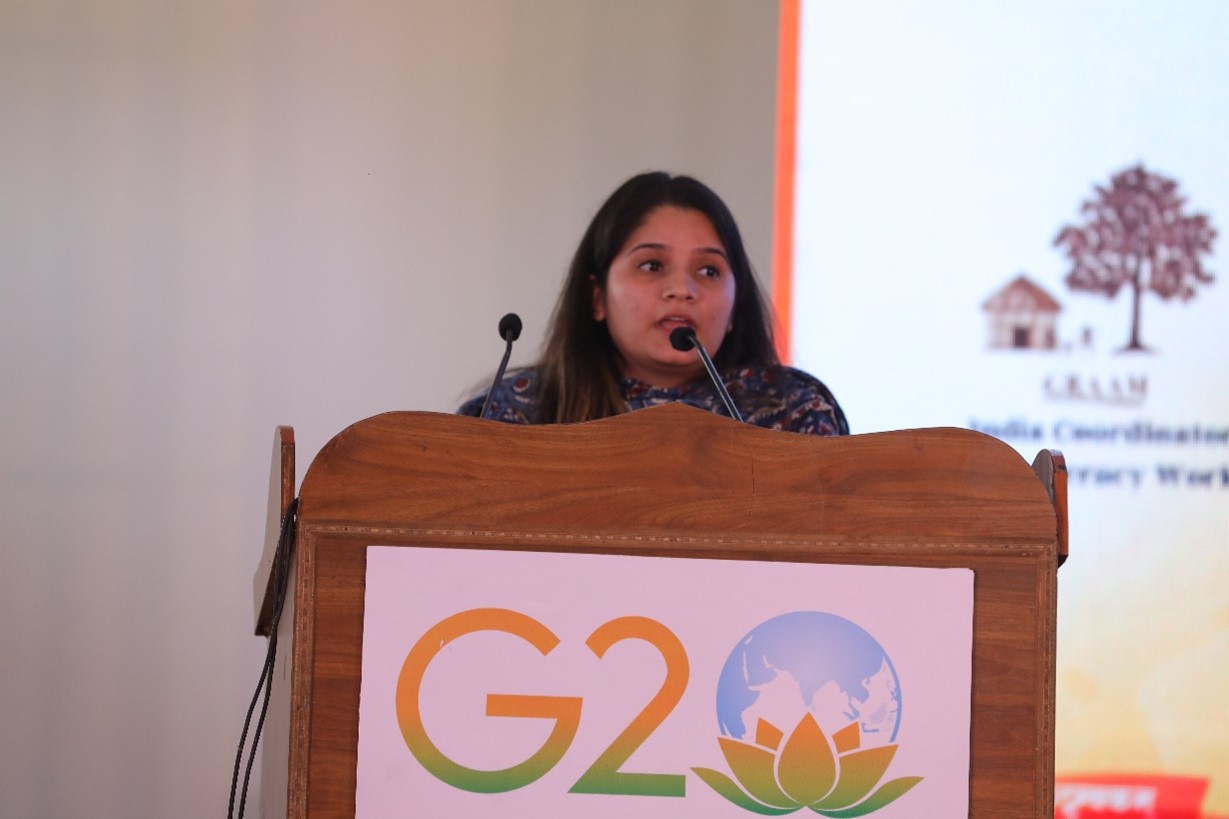 A person speaking into microphones at a podium  Description automatically generated with medium confidence