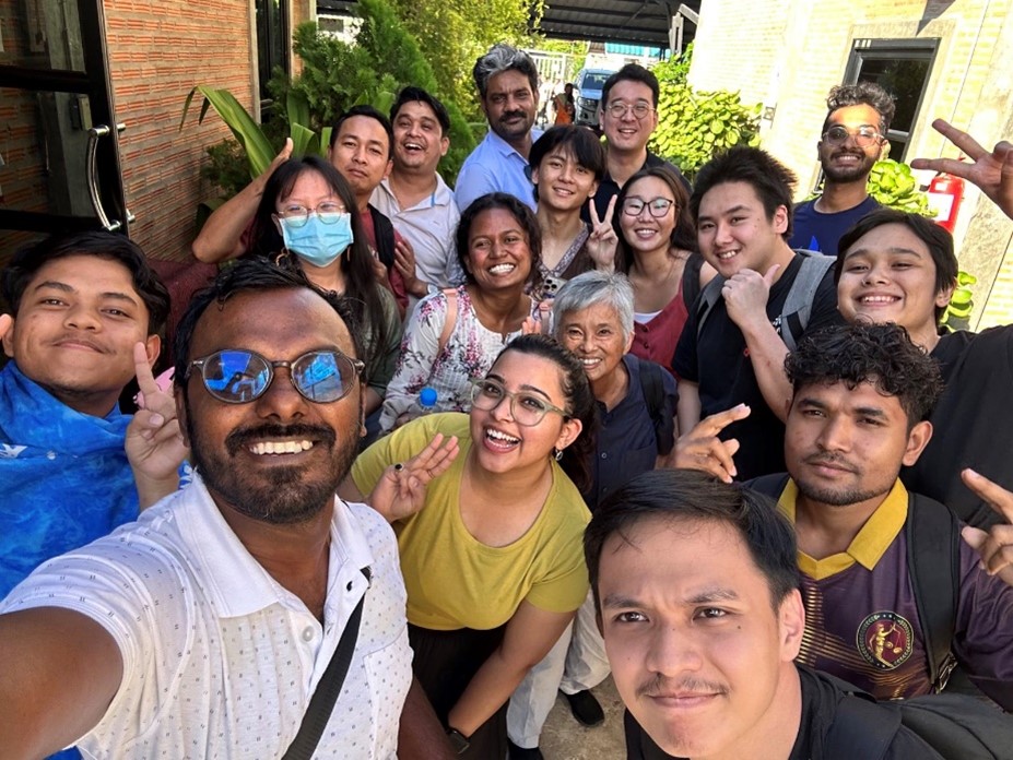 A group of people posing for a selfie  Description automatically generated