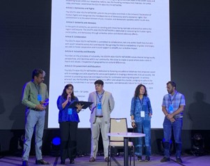 A group of people standing on a stage  Description automatically generated